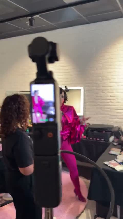 Camera on tripod filming the host